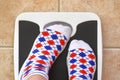 Woman's feet on bathroom scale Royalty Free Stock Photo