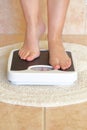 Woman's feet on bathroom scale Royalty Free Stock Photo