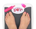 Woman' s feet on bathroom scale Royalty Free Stock Photo