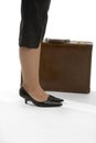 Woman's feet with brief case