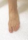 Photo of closeup female feet on white bath mat Royalty Free Stock Photo