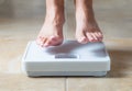 Woman Floating Slightly Above Surface of Weight Scale