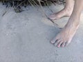 Woman`s feet on the sand of beach Royalty Free Stock Photo