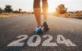 Woman's feet on the road, Starting the New Year 2024 with a run