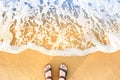 Woman`s feet in sandals on a beach sand Royalty Free Stock Photo