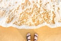 Woman`s feet in sandals on a beach sand Royalty Free Stock Photo