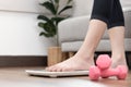 Woman`s feet stepping on electronic scales