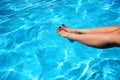 Woman's feet in a swimming pool Royalty Free Stock Photo