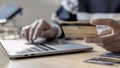 Woman`s finger presses a keyboard and holds a credit card to register for payment or online transactions