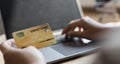 Woman`s finger presses a keyboard and holds a credit card to register for payment or online transactions Royalty Free Stock Photo