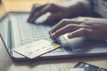 Woman`s finger presses a keyboard and holds a credit card to register for payment or online transactions Royalty Free Stock Photo