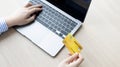 Woman`s finger presses a keyboard and holds a credit card to register for payment or online transactions Royalty Free Stock Photo