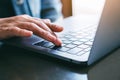 A woman`s finger pressing on the enter button of laptop computer on the table Royalty Free Stock Photo