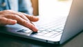 A woman`s finger pressing on the enter button of laptop computer on the table Royalty Free Stock Photo