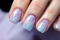 Woman\'s fingernails with pastel colored nail polish