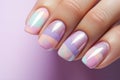 Woman\'s fingernails with pastel colored nail polish