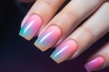 Woman\'s fingernails with pastel colored nail polish