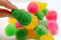 Woman`s Fingers Picking a Vibrant Green Sugar Coated Jelly Candies from the Candy Pile Royalty Free Stock Photo