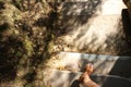 A woman`s foot in a brown sandal and blue nail Polish descends the concrete steps Royalty Free Stock Photo