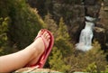 Woman's foot and leg before waterfall