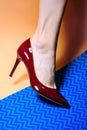 A woman's foot is wearing a chic burgundy patent leather high-heeled pump Royalty Free Stock Photo