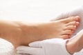 Woman`s french pedicure. Close Up Woman Hands Touching Long Legs Royalty Free Stock Photo