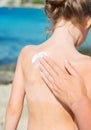 Woman's hand applying suntan cream.