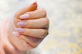 A woman's hand with beautiful pink gel nails. Royalty Free Stock Photo