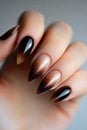 A woman& x27;s hand with a black and gold manicure on it Royalty Free Stock Photo