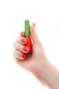 Woman`s hand with a bottle of nail paint. Girl holding in hands a small bottle with colored lacquer. Beautifully painted nails. Royalty Free Stock Photo