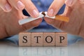 Woman Breaking Cigarette Over Stop Wooden Blocks Royalty Free Stock Photo