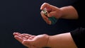 A woman`s hand is cleaning with an antiseptic spay.