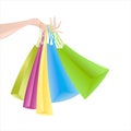 Woman`s hand with colorful bags