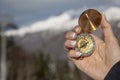 A  woman`s hand with  compass on the high mountains landscape Royalty Free Stock Photo