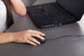 Woman`s hand with computer mouse on table. Black computer Royalty Free Stock Photo