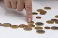 A woman`s hand counts metal coins from a wallet on a table on a white background. Concept: small pension, poverty, lack of money f Royalty Free Stock Photo