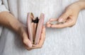 A woman`s hand counts the remaining money over a pink purse held in the other hand. Selective focus, close-up. Concept Royalty Free Stock Photo