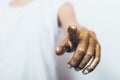 Woman`s hand covered with gold sequins pointing finger