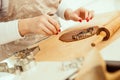 Woman`s hand cuts off Christmas dough