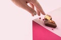 Woman& x27;s hand with dark handmade chocolate with berries and nuts