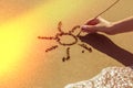 A woman`s hand draws the sun on the sand by the sea, the glow effect Royalty Free Stock Photo