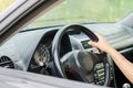 Woman's hand driving a car.