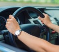 Woman's hand driving a car.