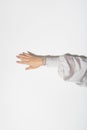 woman's hand in elegant silk clothes with shiny jewelry on a white background in hard light