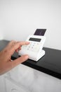 Woman's hand entering a PIN code on a payment terminal