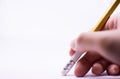 A woman`s hand is erasing something with the rubber sticking with the pencil on the white background