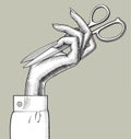 Woman`s hand with folded scissors