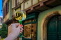 Woman holding a glass of Gewurztraminer wine in Colmar France, Alsace Wine Route