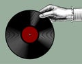 Woman`s hand with a gramophone record