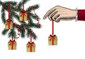 A woman`s hand hangs Christmas gifts with a red ribbon on the Christmas tree